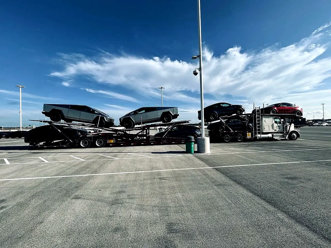 Multi-car carrier with vehicles positioned across the upper and lower decks.