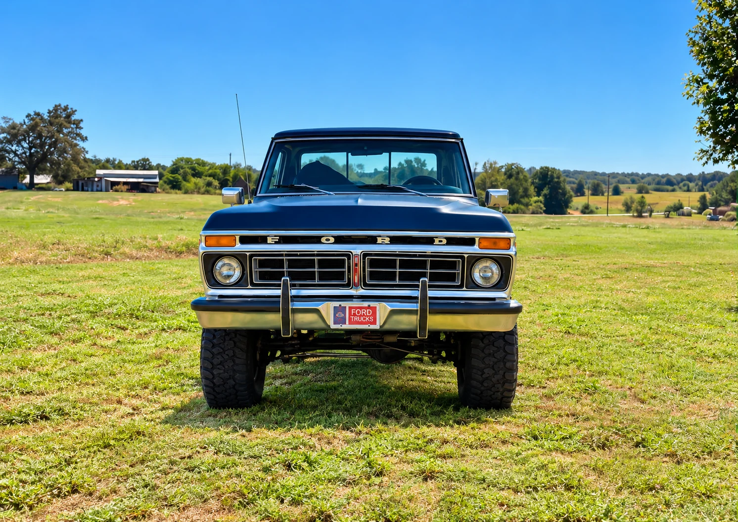 Lifted blue-and-white Ford F-150 shown from the front.