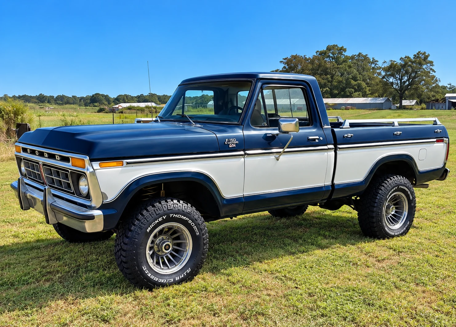Lifted blue-and-white Ford F-150 shown from the side.