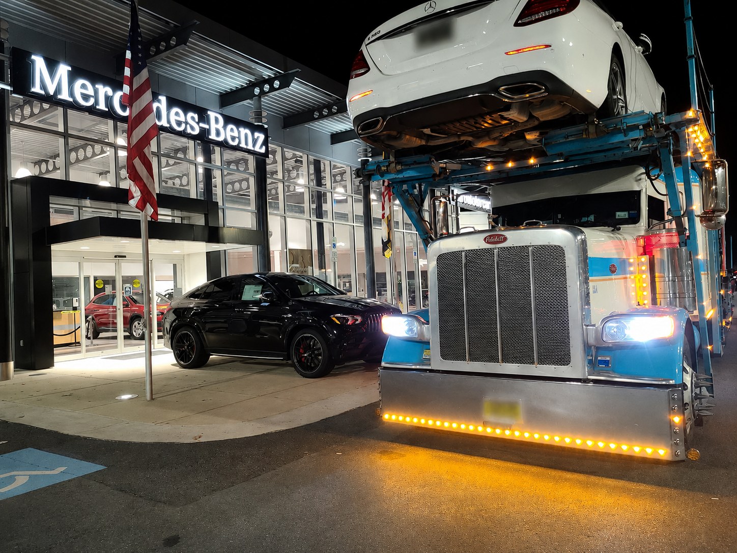 Gold Coast auto transport truck at a Mercedes-Benz dealership